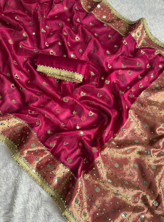 Magenta saree close-up with gold zari trim and beige floral print pallu section