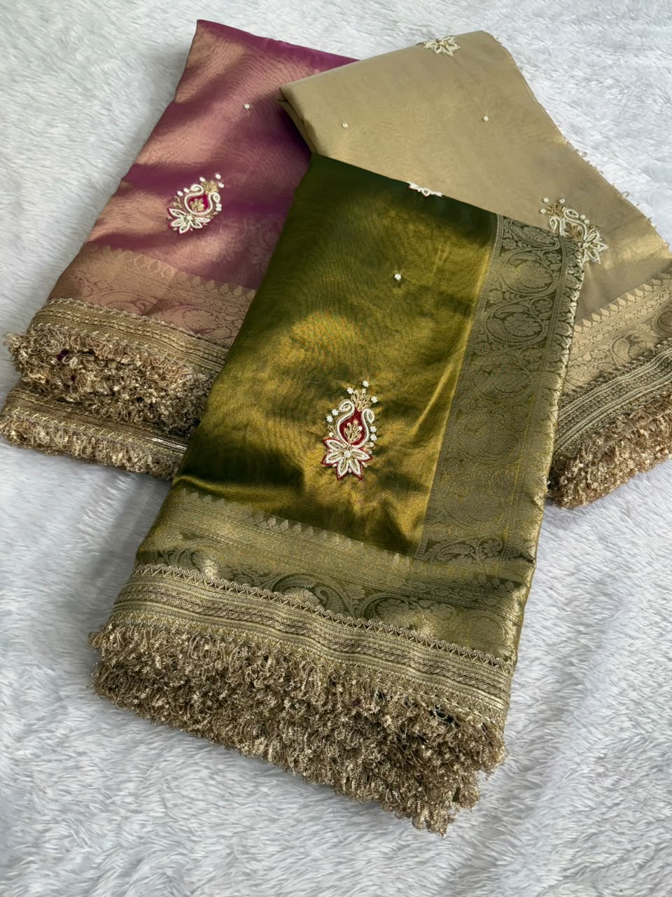 Tissue saree with gold zari border, pink and olive green folds, embroidered motifs