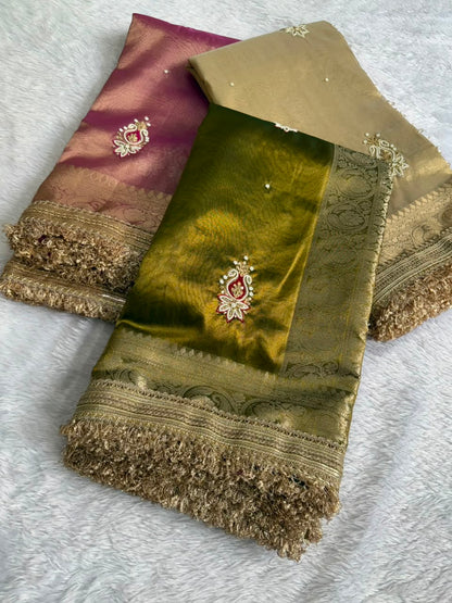 Tissue saree with gold zari border, pink and olive green folds, embroidered motifs