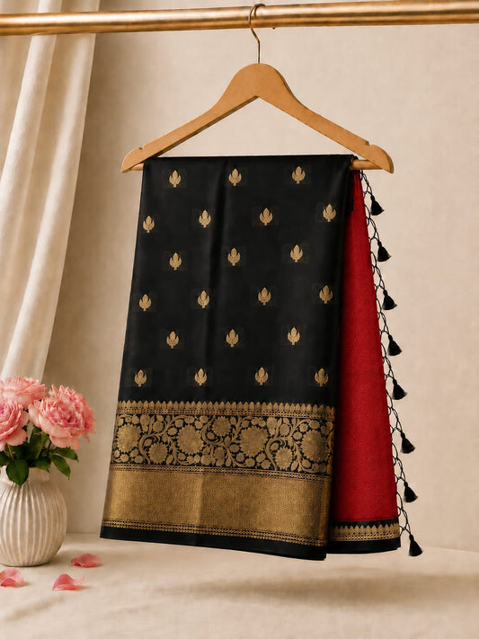 Half-and-half saree with black body, gold border, maroon drape accents, tassels