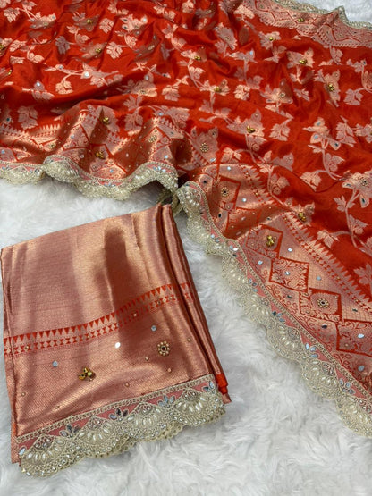 Coral-red designer saree with matching blouse piece and ornate silver-gold border