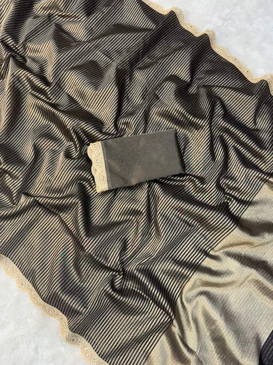 Black and gold striped tissue saree with gold-trimmed border and draped folds