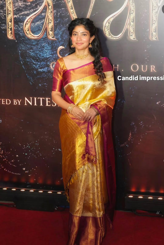 Women’s gold tissue saree with magenta border and patterned pallu, worn over one shoulder.