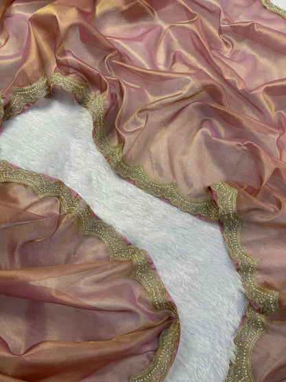 Mauve tissue fabric with scalloped gold embroidered edge, folded view