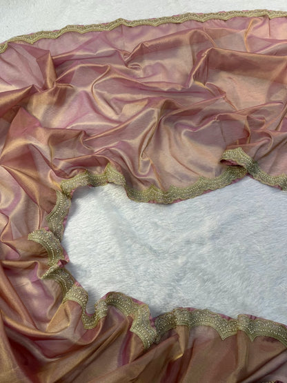 Mauve tissue saree with scalloped gold embroidered border, spread flat on base