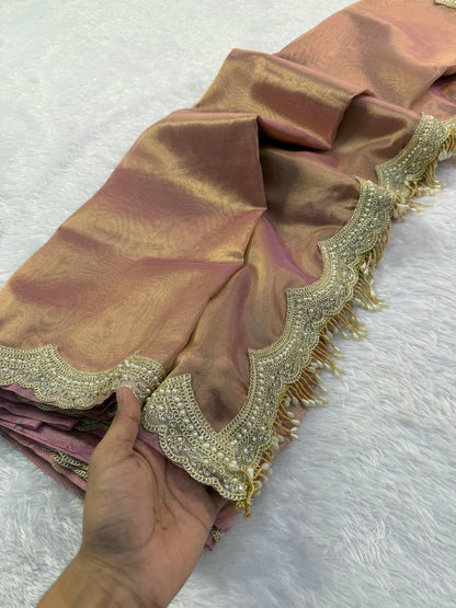 Mauve tissue saree corner with ornate scalloped gold embroidery on edge