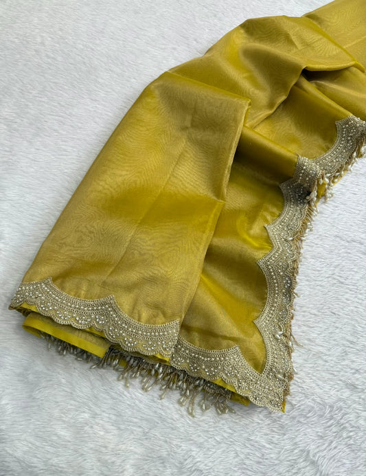 Gold-yellow saree corner with scalloped silver embellished border on white fabric