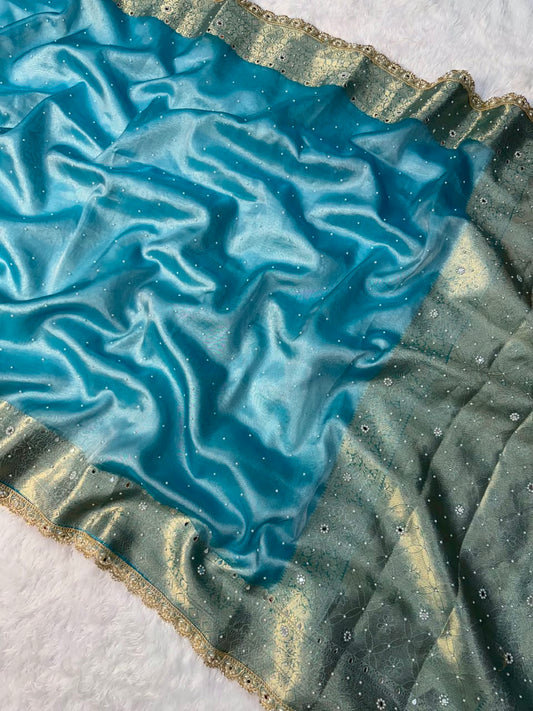 Hot sky blue tissue saree close-up with shimmering gold-edged border