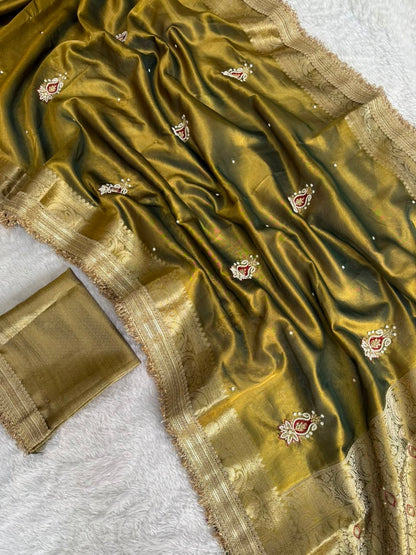 Olive green tissue saree with gold zari border and small embroidered motif details