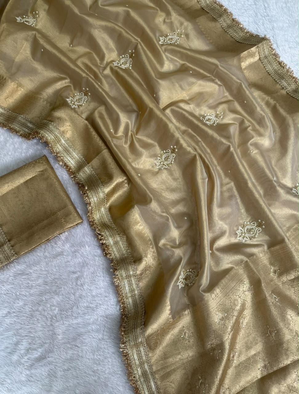 Ivory gold tissue saree with gold zari border and small embroidered motif details