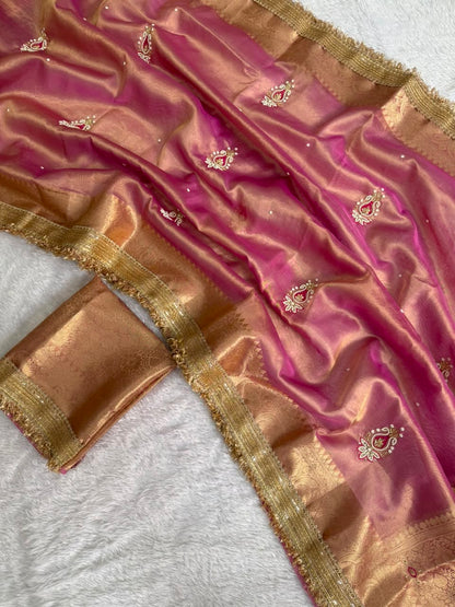 Pink tissue saree with gold zari border and small embroidered motifs, folded