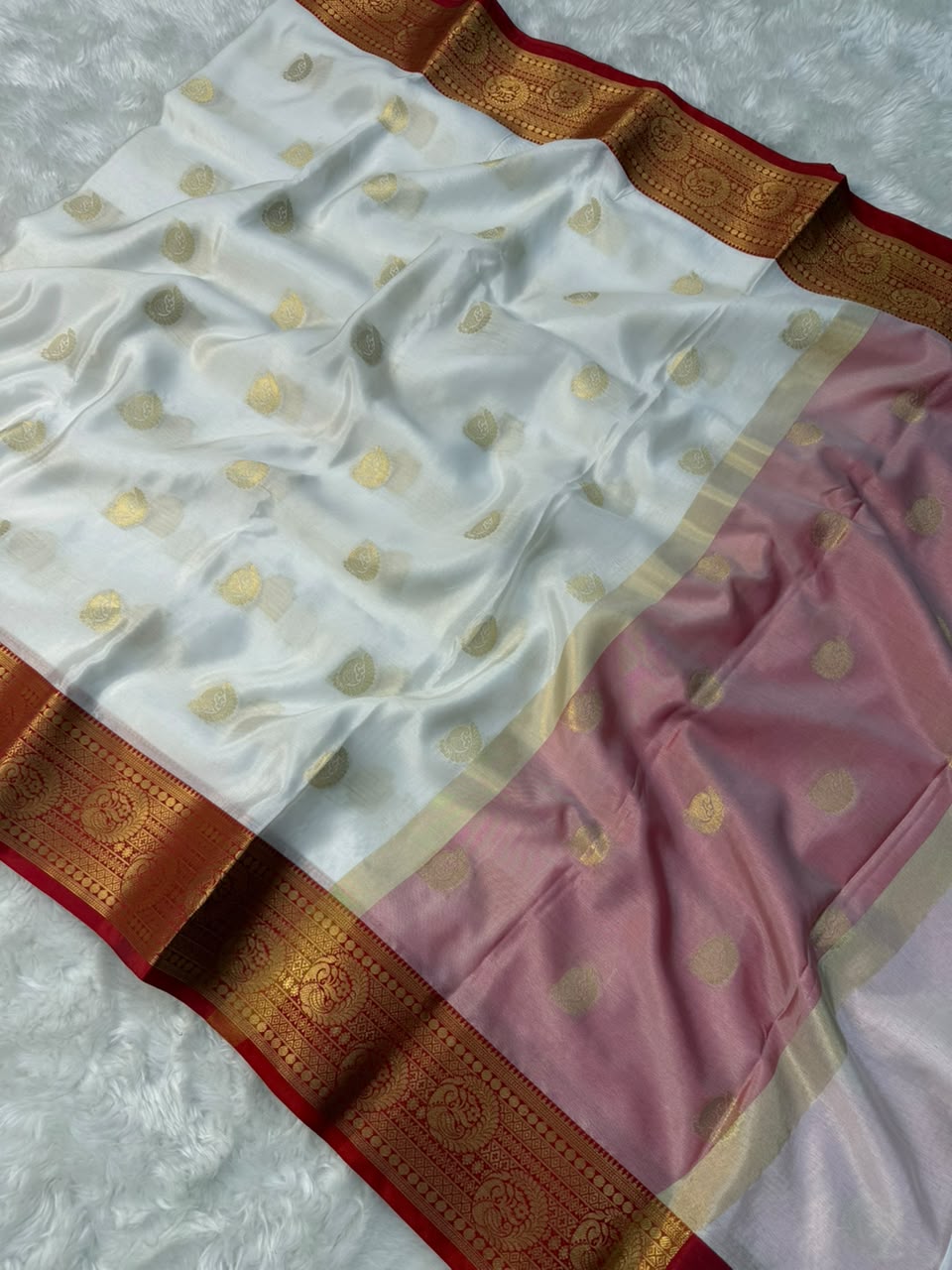 White tapeta saree with gold dot pattern, pink drape section, and red-gold zari border