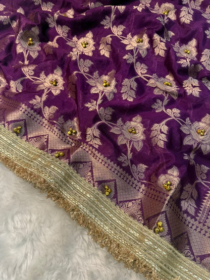 Purple silk saree with embroidered floral vines, jeweled accents, and gold fringe border