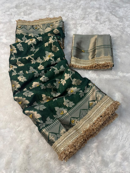 Warm silk gungroo saree in deep green with gold floral print and wide textured border.