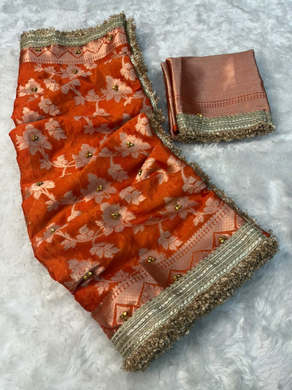 Warm silk gungroo saree in orange with gold floral embroidery and shimmering border.